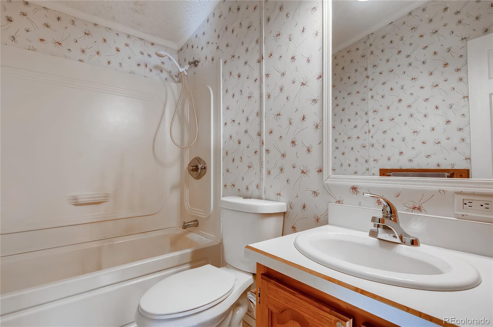 13801 Cavanaugh Road Hudson, CO 80642 - Photo 19 of 39 a bathroom with a sink toilet and shower