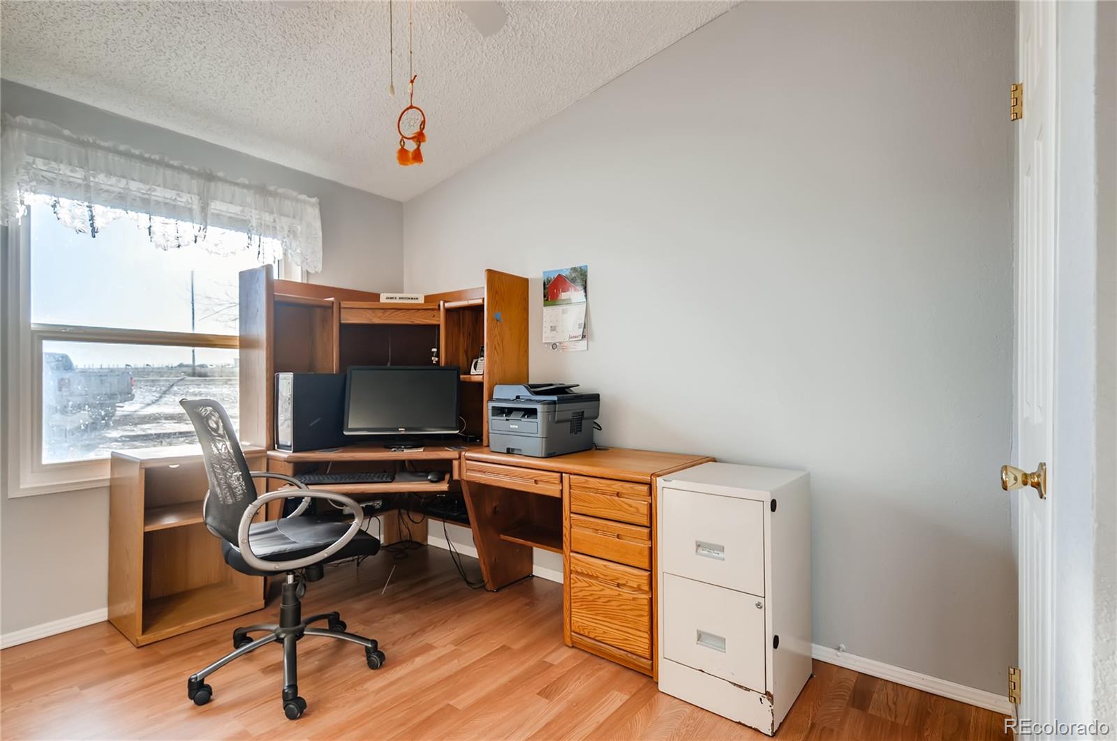 13801 Cavanaugh Road Hudson, CO 80642 - Photo 20 of 39 a view of a workspace with furniture and a window