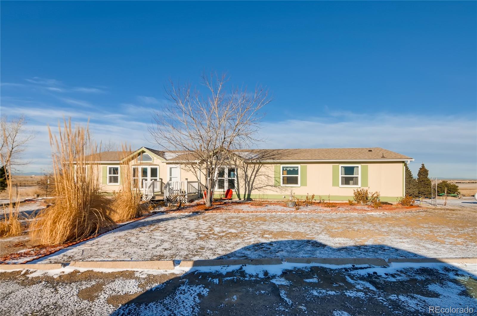 13801 Cavanaugh Road Hudson, CO 80642 - Photo 2 of 39 a front view of a house with a yard