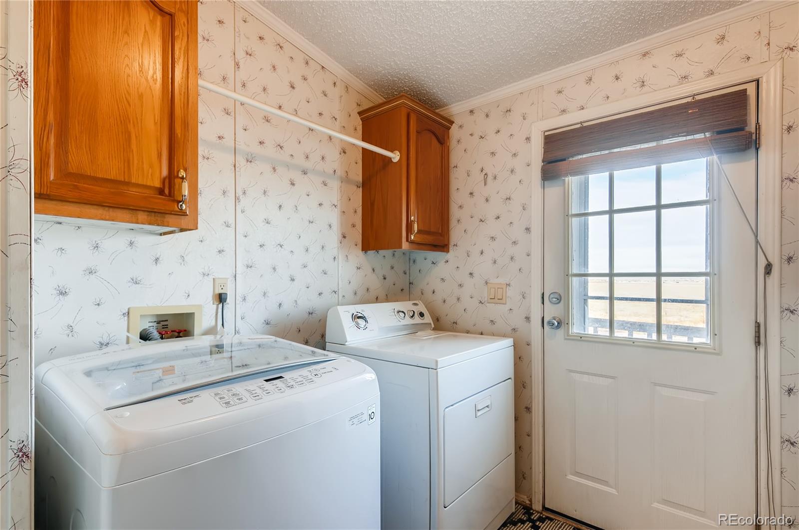 13801 Cavanaugh Road Hudson, CO 80642 - Photo 24 of 39 a utility room with dryer and washer