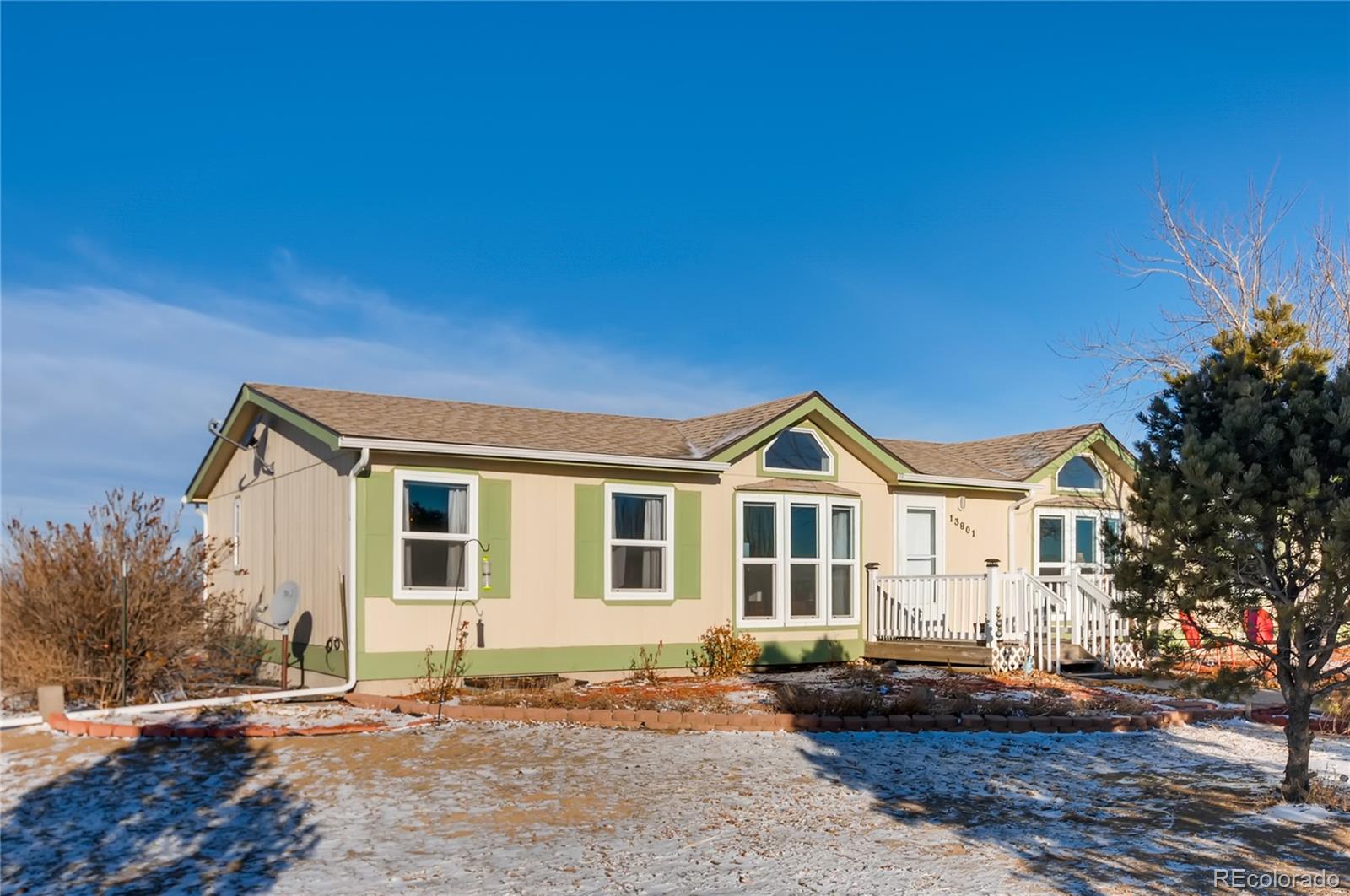 13801 Cavanaugh Road Hudson, CO 80642 - Photo 3 of 39 a front view of a house with a yard