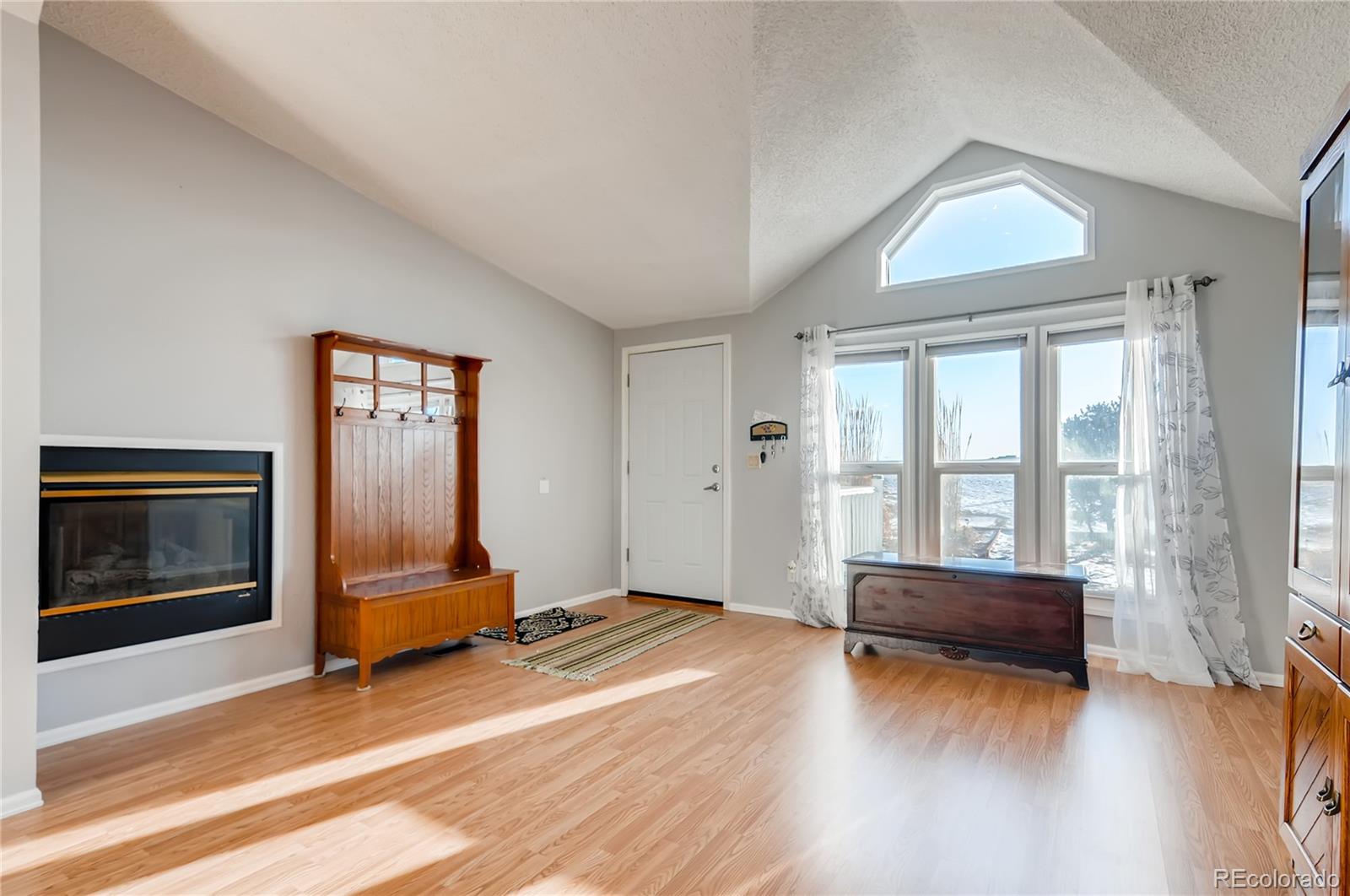 13801 Cavanaugh Road Hudson, CO 80642 - Photo 7 of 39 a living room with furniture window and flat screen tv