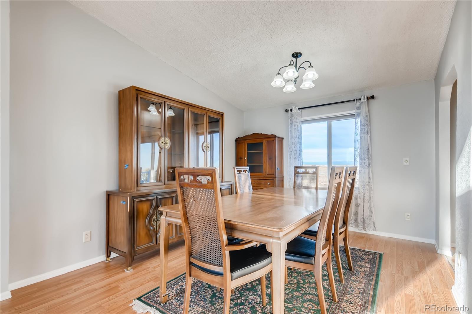 13801 Cavanaugh Road Hudson, CO 80642 - Photo 8 of 39 a view of a dining room with furniture and wooden floor