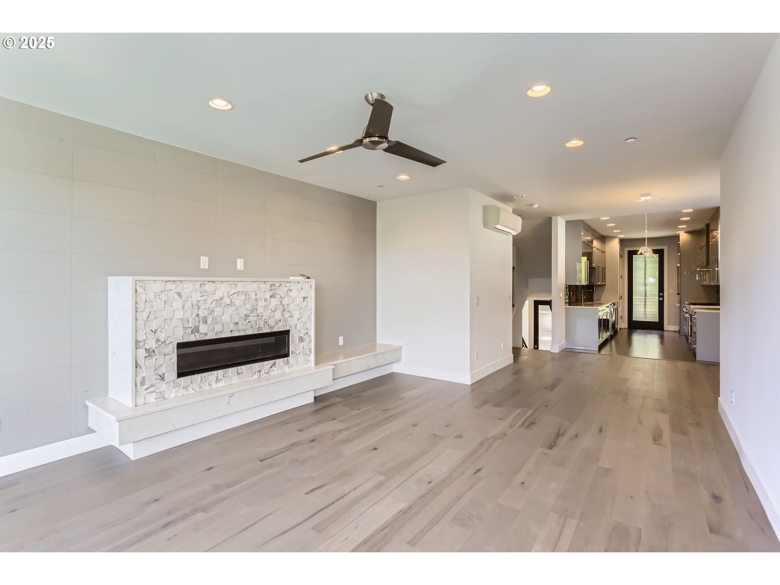 1625 Southwest Montgomery Street, Unit C Portland, OR 97201 - Photo 9 of 41 a view of an empty room with wooden floor and a fireplace