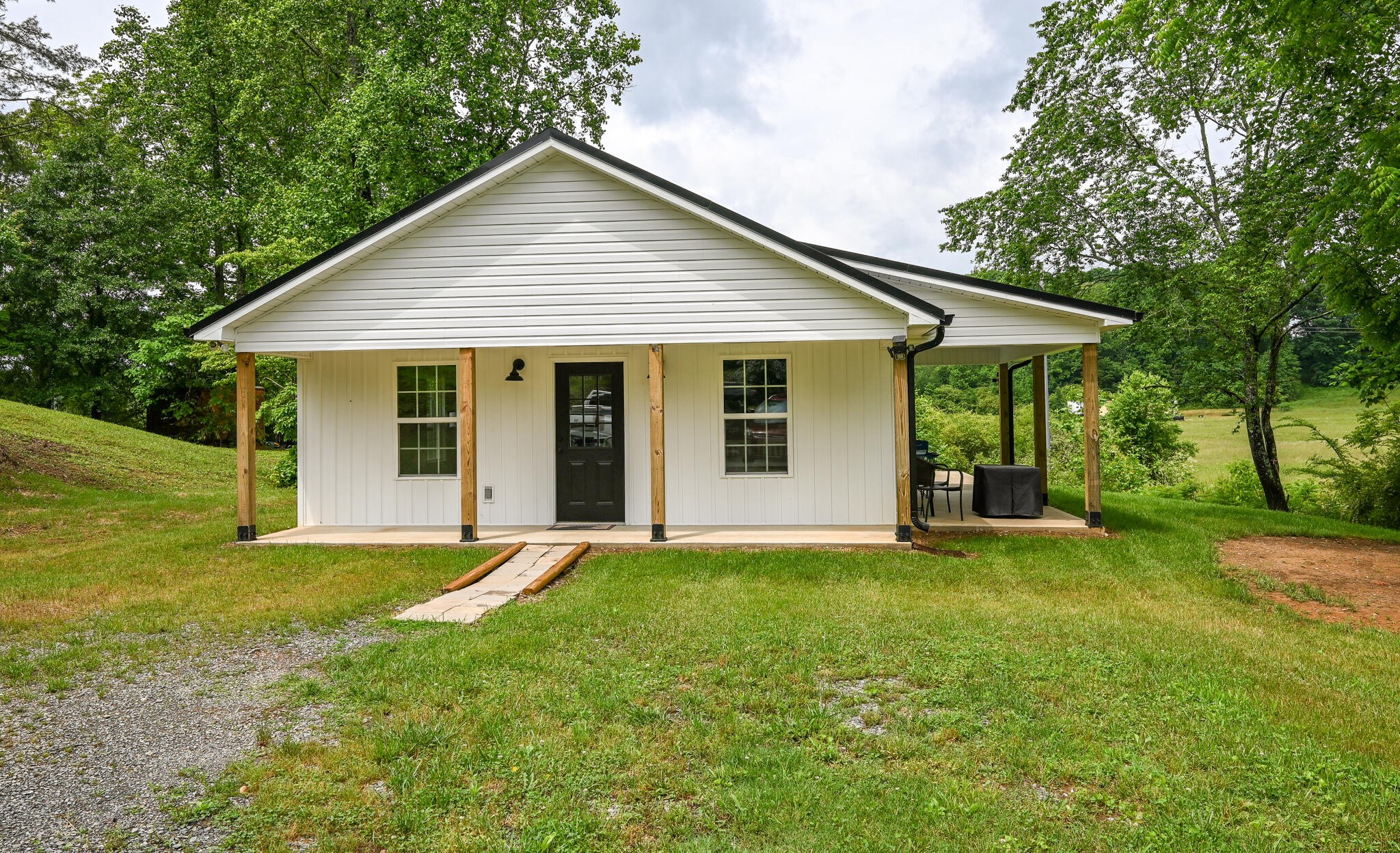 807 Parksville Road Benton, TN 37307 - Photo 3 of 35 a view of a house with a yard and large tree
