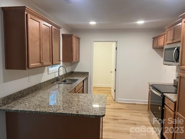 429 Fleetwood Road York, SC 29745 - Photo 6 of 9 a kitchen with granite countertop a sink a stove and a wooden cabinets