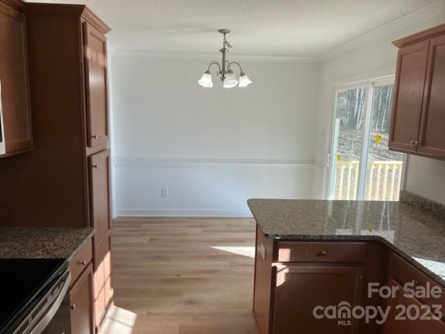 429 Fleetwood Road York, SC 29745 - Photo 7 of 9 a kitchen with granite countertop a stove and a refrigerator