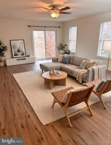 a living room with furniture and a wooden floor