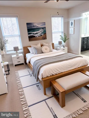 a bedroom with a bed a mirror and a flat tv screen on the dresser