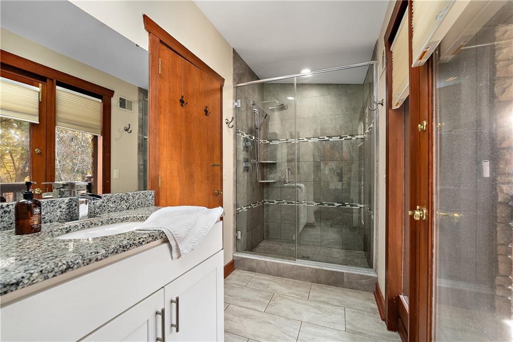 178 Backbone Road Sewickley, PA 15143 - Photo 14 of 25 a bathroom with a granite countertop sink and shower