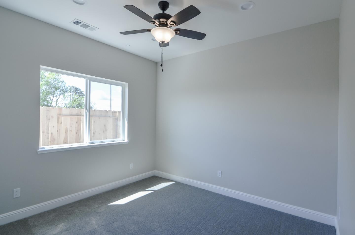 684 South Mohler Road Ripon, CA 95366 - Photo 24 of 41 an empty room with a window and a fan
