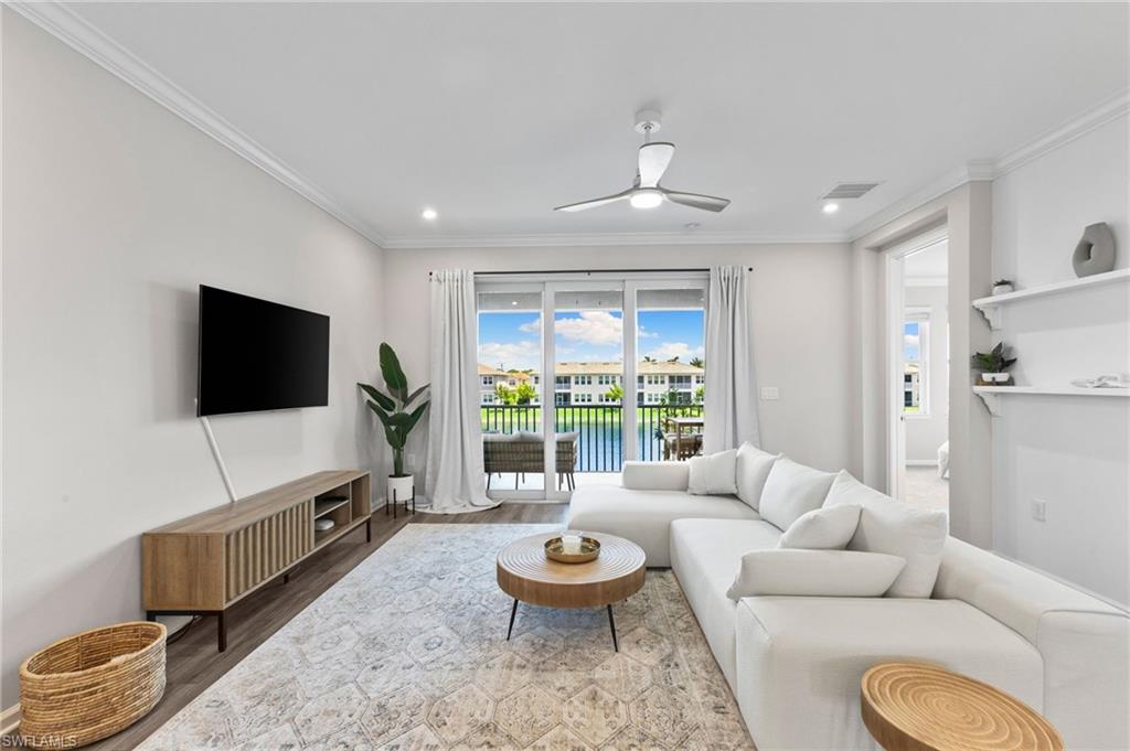 4607 Arboretum Circle, Unit 202 Naples, FL 34112 - Photo 16 of 39 a living room with furniture and a flat screen tv