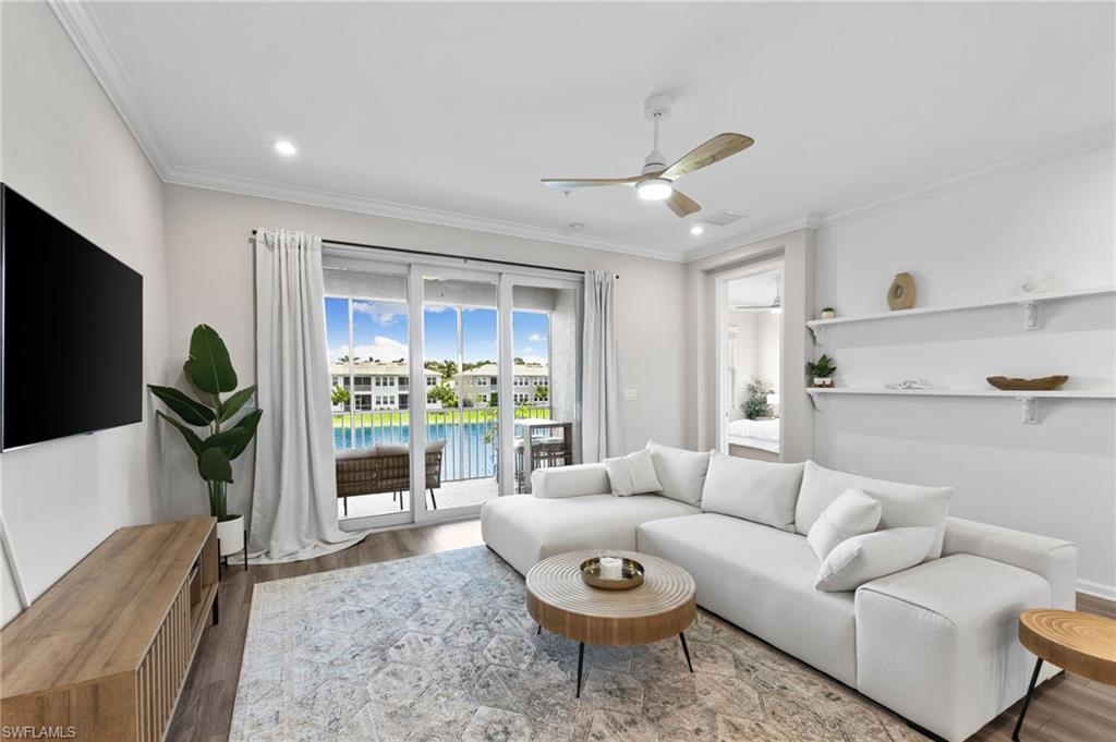 4607 Arboretum Circle, Unit 202 Naples, FL 34112 - Photo 17 of 39 a living room with furniture and a large window