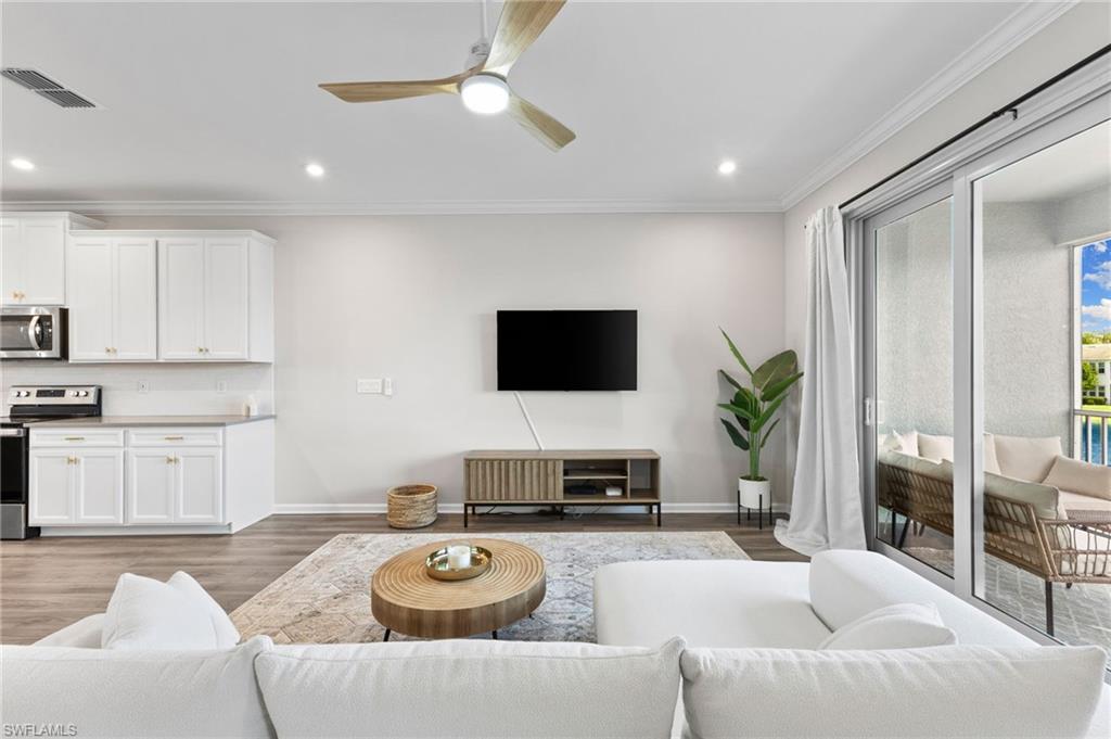 4607 Arboretum Circle, Unit 202 Naples, FL 34112 - Photo 18 of 39 a living room with furniture and a flat screen tv