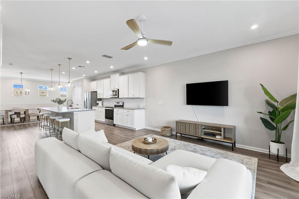4607 Arboretum Circle, Unit 202 Naples, FL 34112 - Photo 19 of 39 a living room with furniture and a flat screen tv