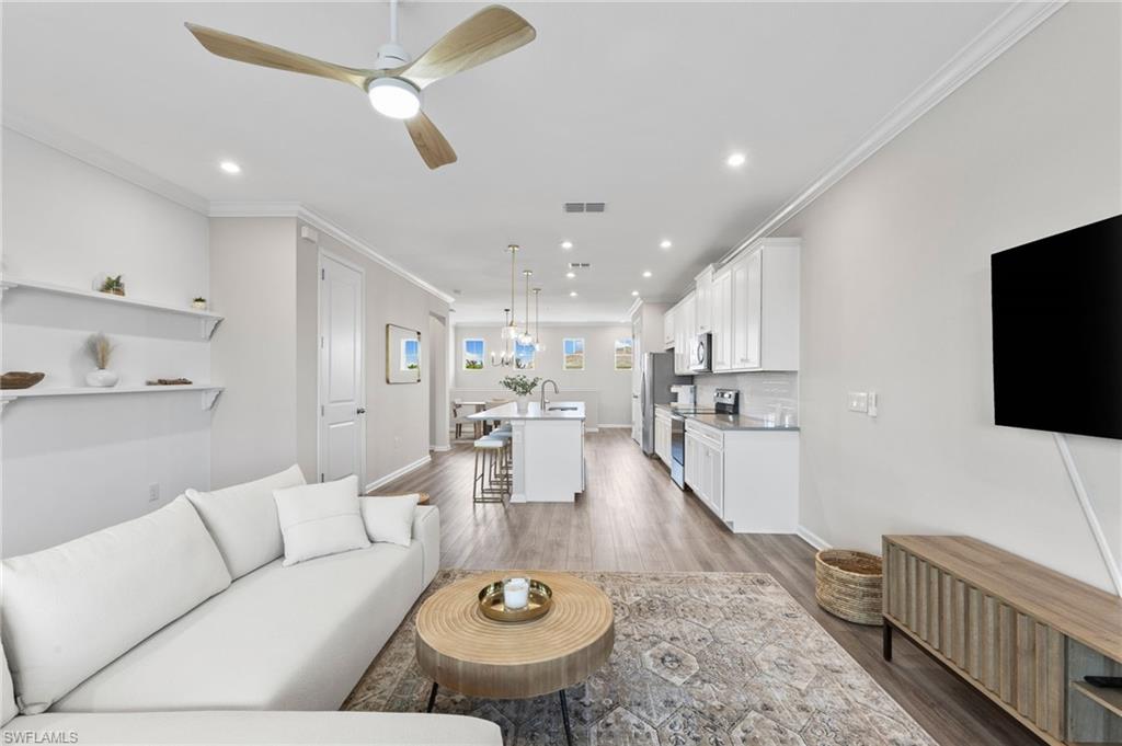 4607 Arboretum Circle, Unit 202 Naples, FL 34112 - Photo 20 of 39 a living room with furniture and a flat screen tv