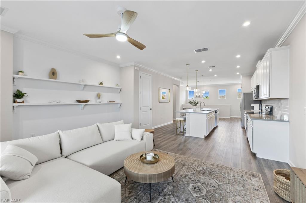 4607 Arboretum Circle, Unit 202 Naples, FL 34112 - Photo 21 of 39 a living room with stainless steel appliances furniture and a kitchen view