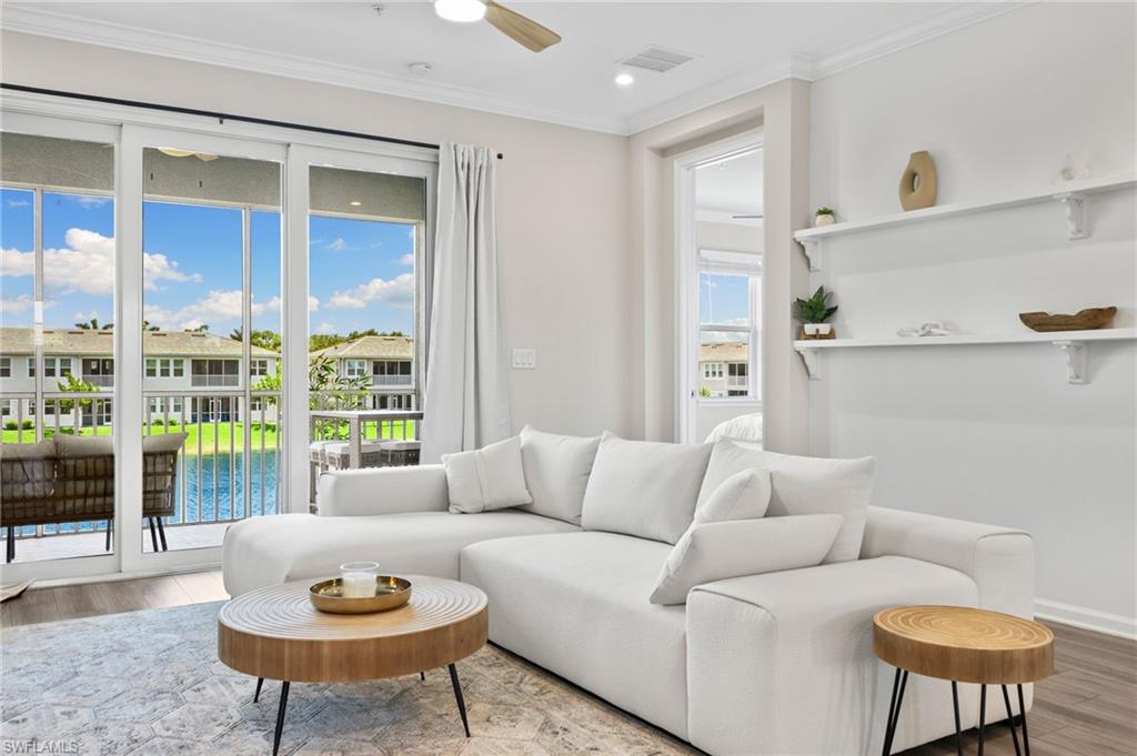 4607 Arboretum Circle, Unit 202 Naples, FL 34112 - Photo 33 of 39 a living room with furniture and a potted plant