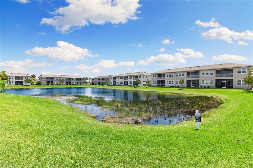 4607 Arboretum Circle, Unit 202 Naples, FL 34112 - Photo 37 of 39 a view of a lake with a house in the background