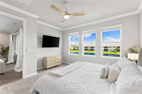 a bedroom with a bed a flat screen tv and a couch