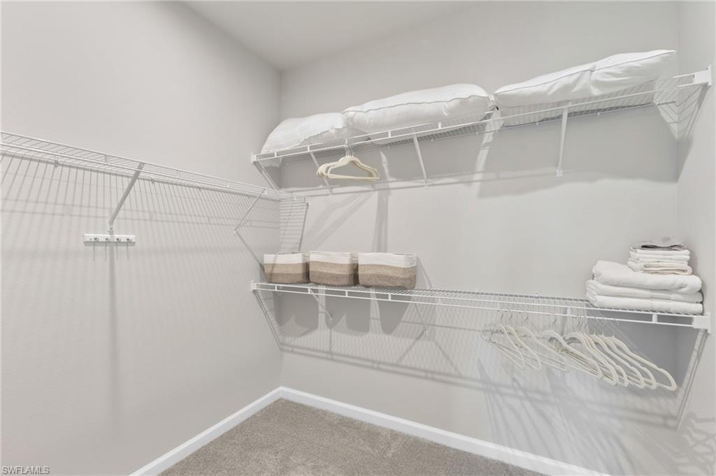 4607 Arboretum Circle, Unit 202 Naples, FL 34112 - Photo 9 of 39 a view of a room with racks on the wall