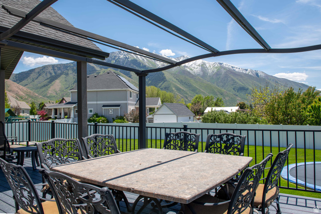 646 East 1400th Street North Mapleton, UT 84664 - Photo 69 of 78 Spacious outdoor deck featuring a dark composite surface, black metal railing, and a pergola structure