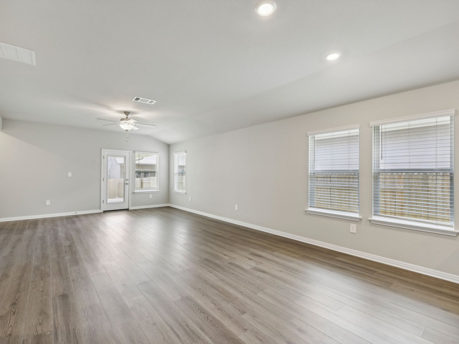 128 Hayburner Road Burnet, TX 78611 - Photo 3 of 12 a view of an empty room with wooden floor and a window