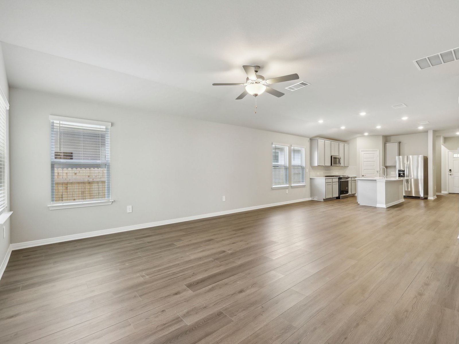 128 Hayburner Road Burnet, TX 78611 - Photo 4 of 12 a view of empty room with wooden floor and kitchen view