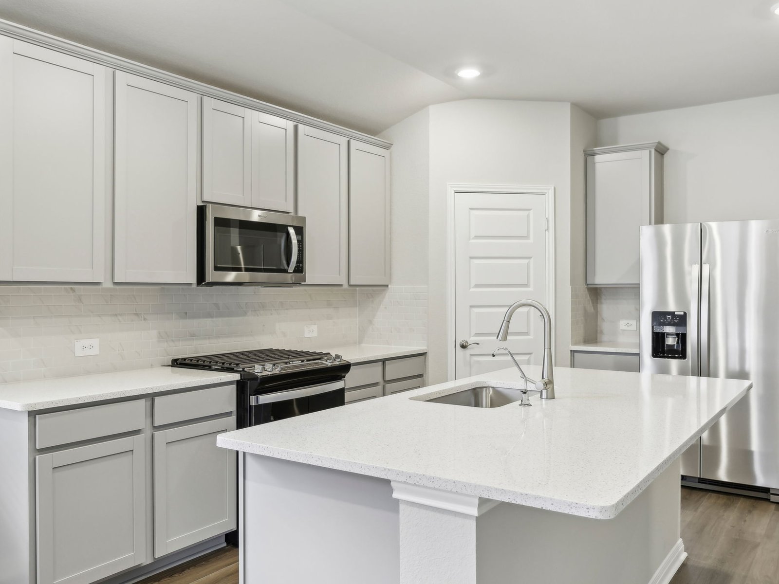 128 Hayburner Road Burnet, TX 78611 - Photo 5 of 12 a kitchen with appliances a sink and cabinets