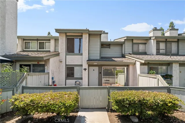 front view of a house with a large window and a yard