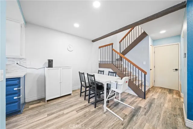 a view of a kitchen with furniture and wooden floor