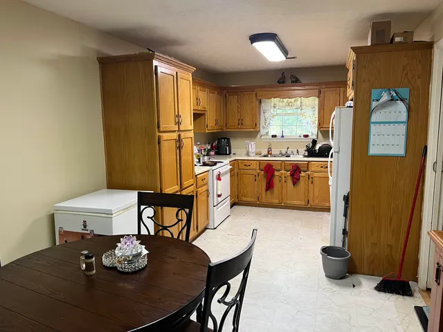 a kitchen with a table and chairs in it
