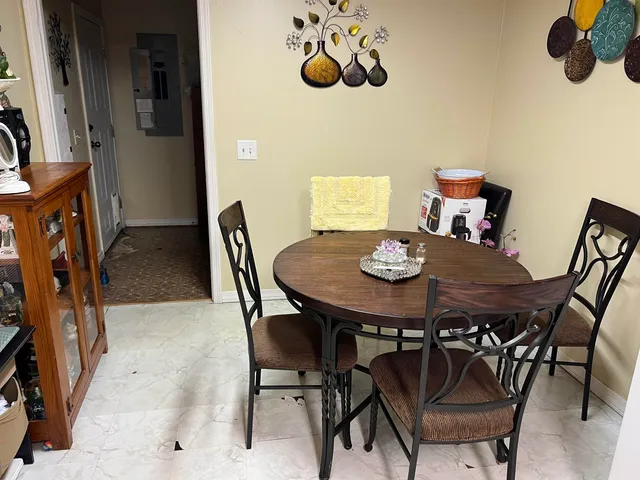 a view of a dining room with furniture and chandelier