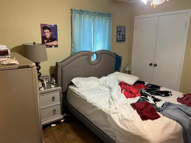 a bedroom with a bed and a chair