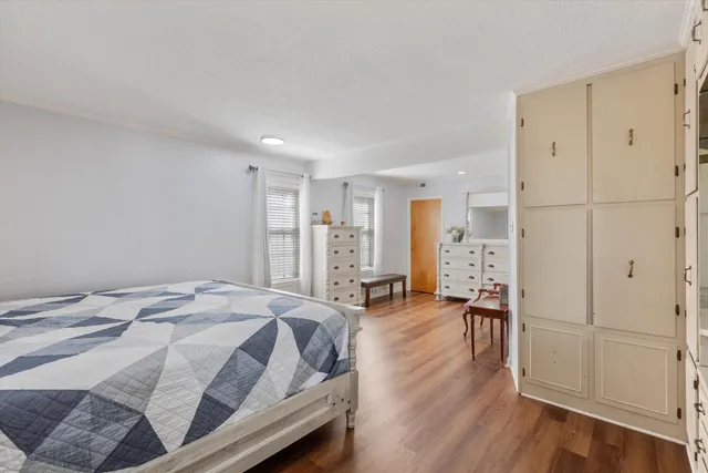 a bed room with a bed and a chair