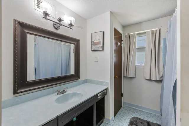 a bathroom with a sink a vanity and a mirror