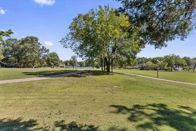 a view of a park and trees in the background