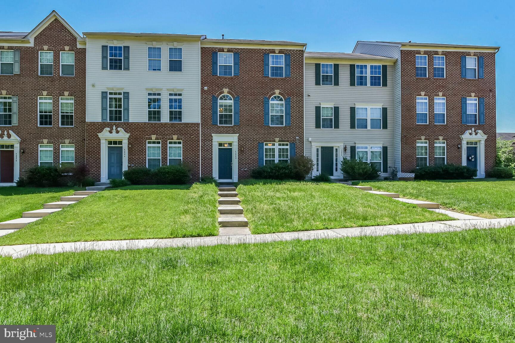 a front view of building with yard and green space