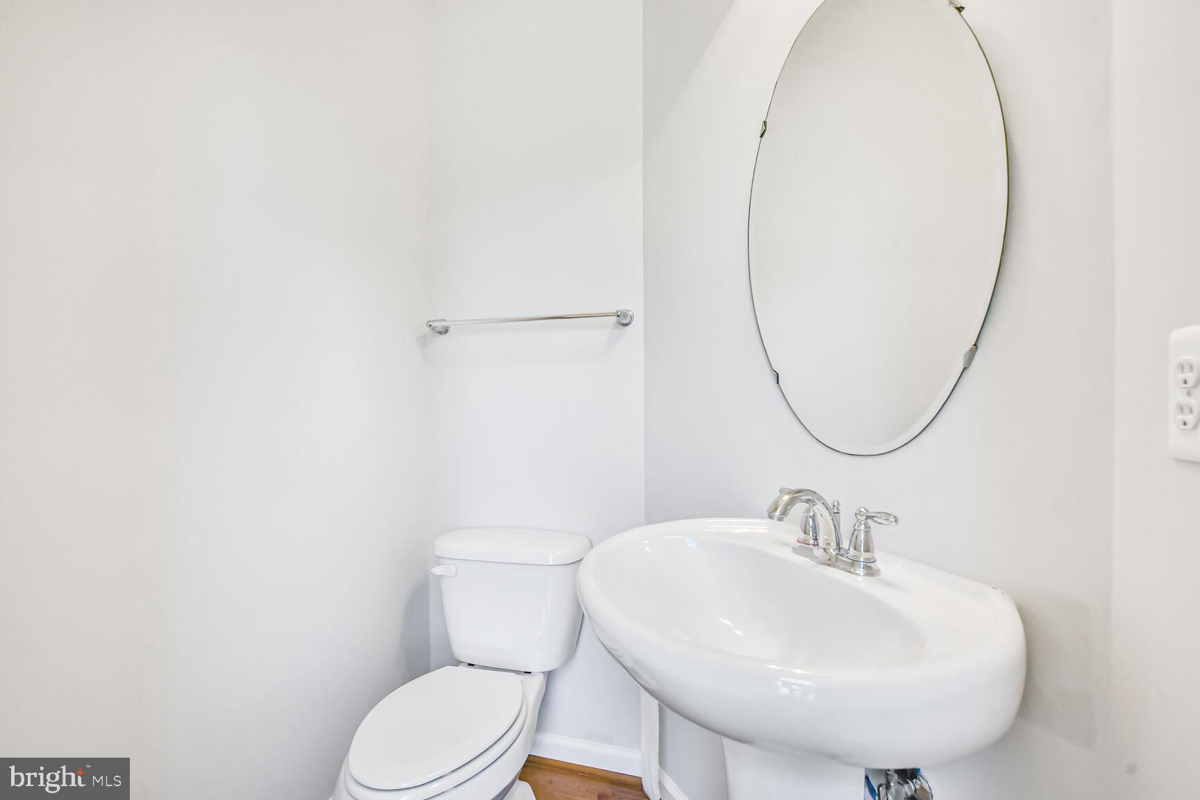 42952 Miltec Terrace Chantilly, VA 20152 - Photo 13 of 30 a bathroom with a sink a mirror and a toilet