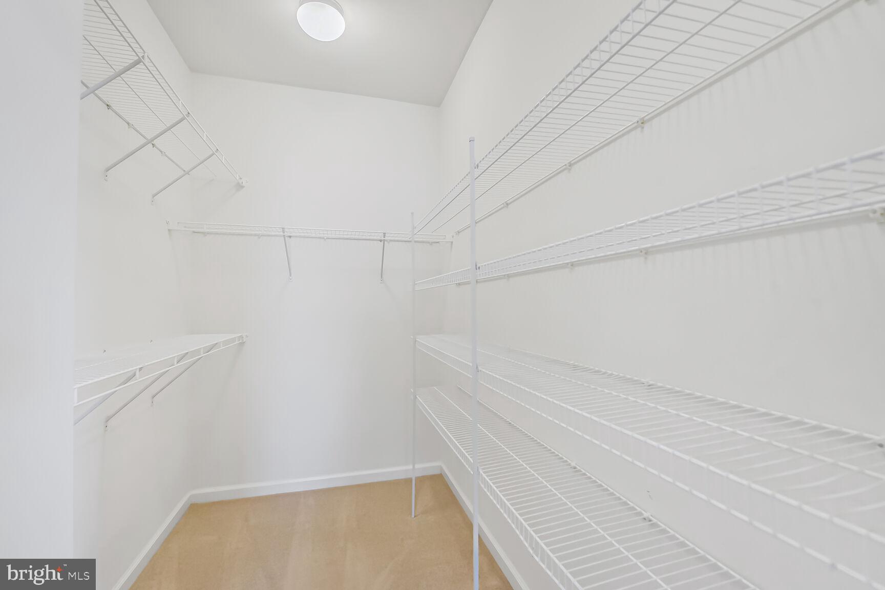42952 Miltec Terrace Chantilly, VA 20152 - Photo 18 of 30 a view of a room with racks on the wall