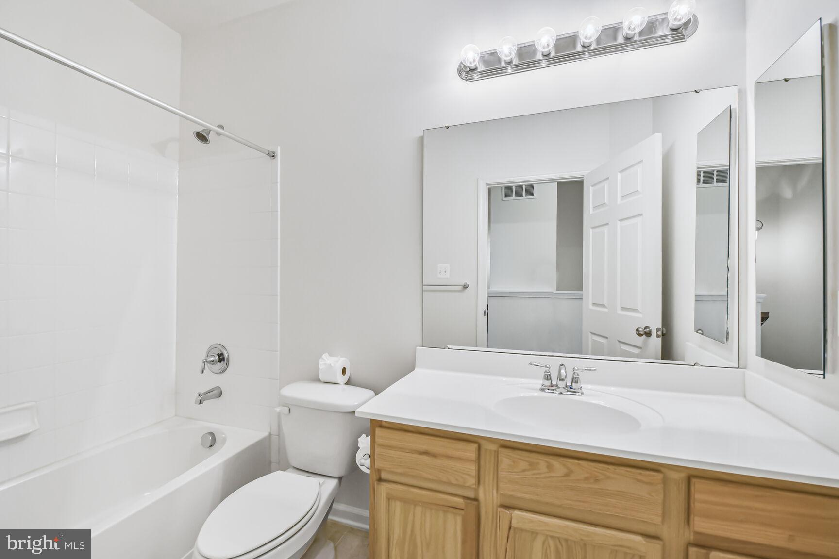 42952 Miltec Terrace Chantilly, VA 20152 - Photo 20 of 30 a bathroom with a sink toilet a shower and a bathtub
