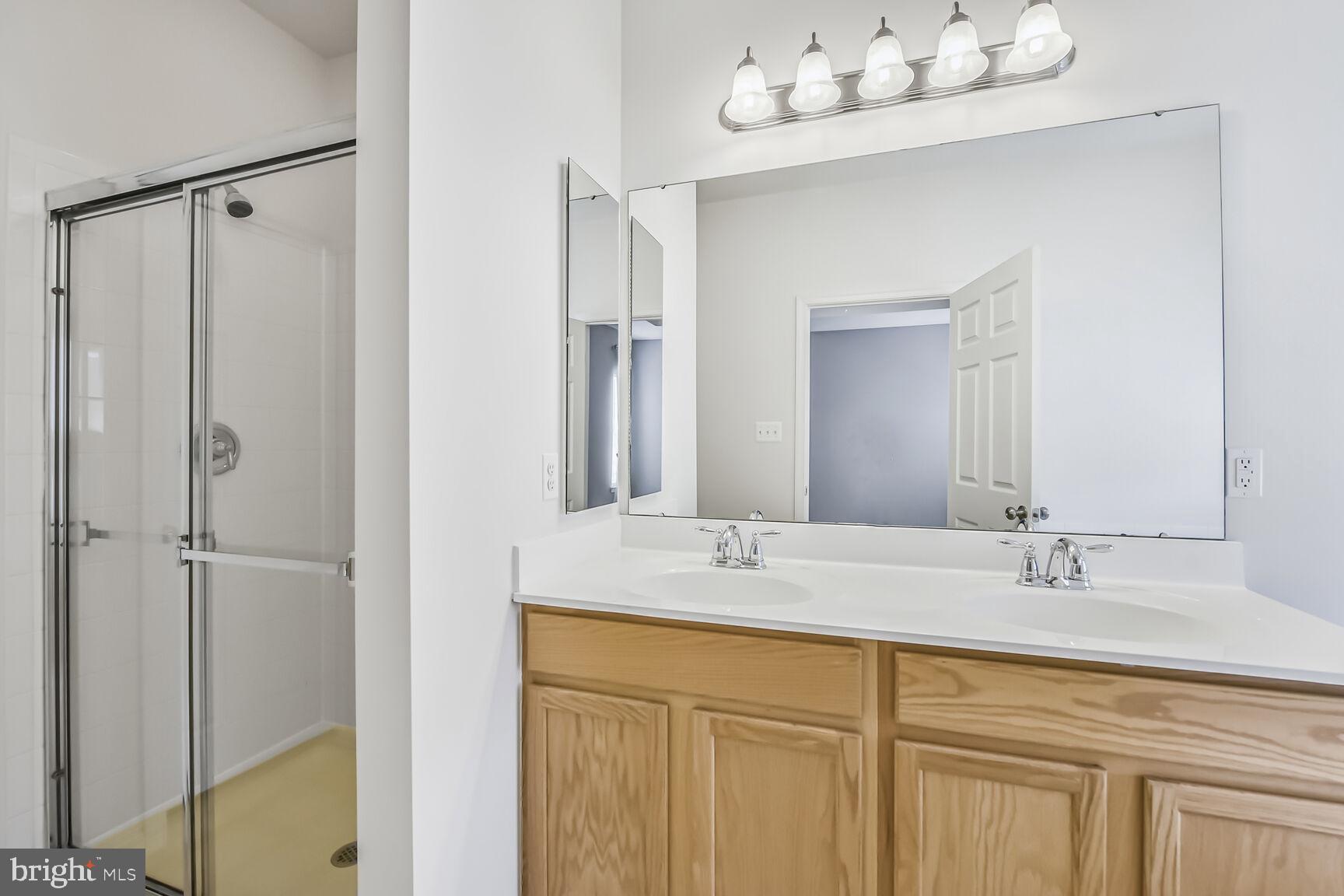 42952 Miltec Terrace Chantilly, VA 20152 - Photo 21 of 30 a bathroom with a sink vanity and a mirror