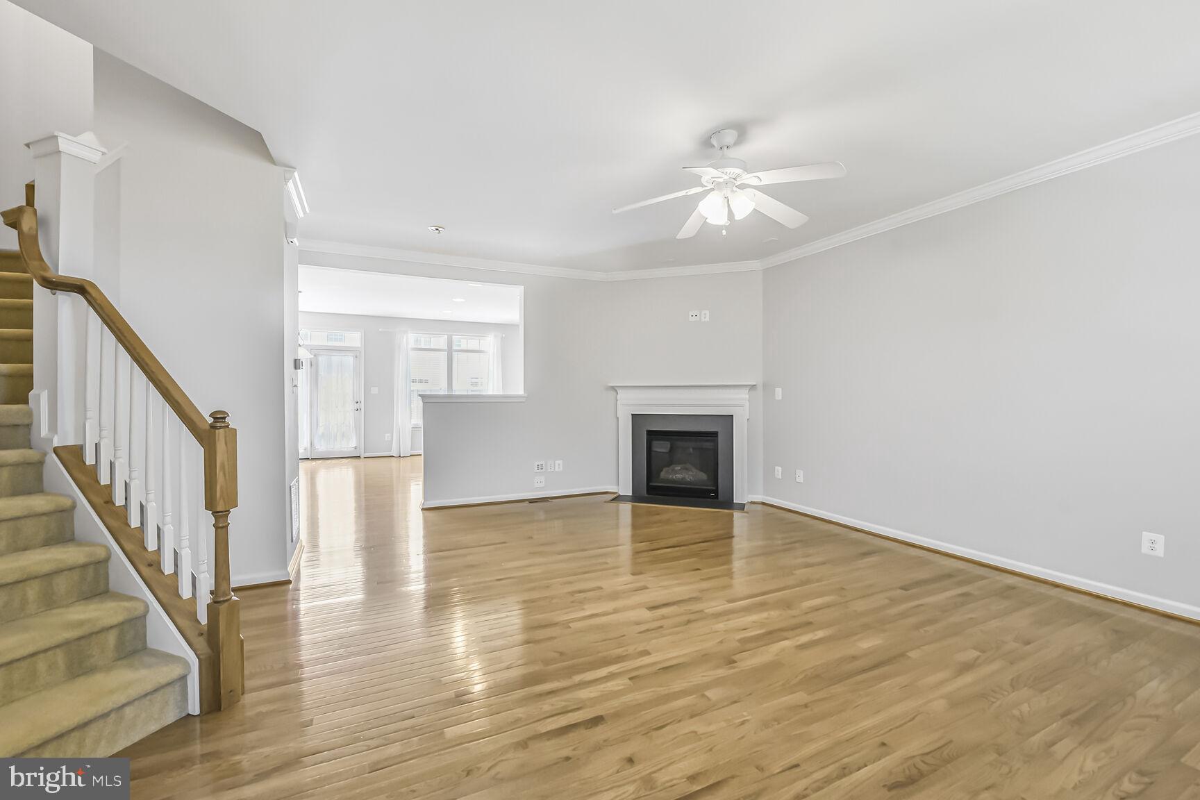 42952 Miltec Terrace Chantilly, VA 20152 - Photo 7 of 30 an empty room with wooden floor fan and windows