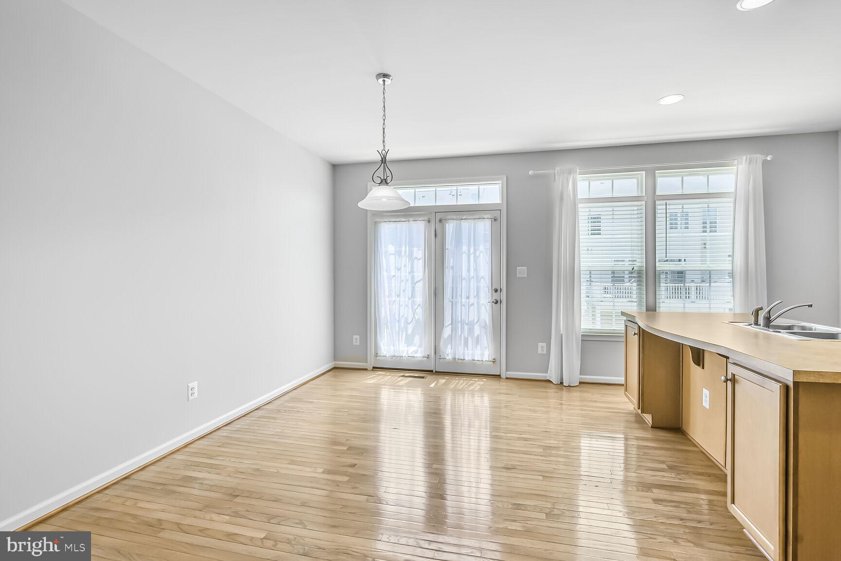 42952 Miltec Terrace Chantilly, VA 20152 - Photo 8 of 30 a view of empty room with wooden floor and fan