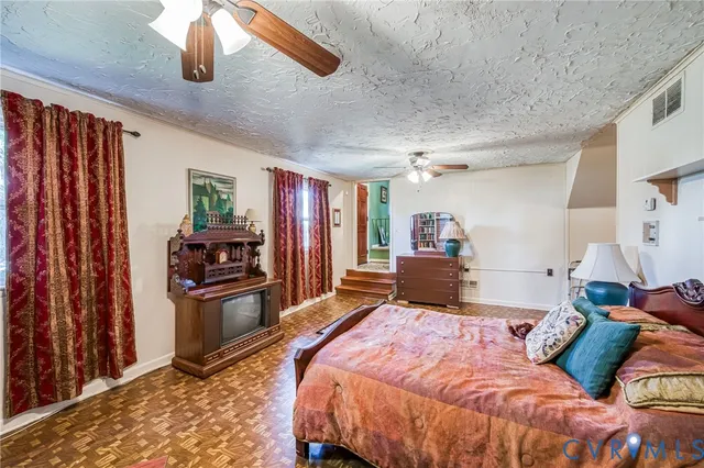 a bedroom with a bed dresser and a window