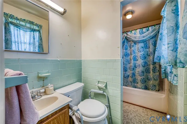 a bathroom with a sink mirror toilet and bathtub