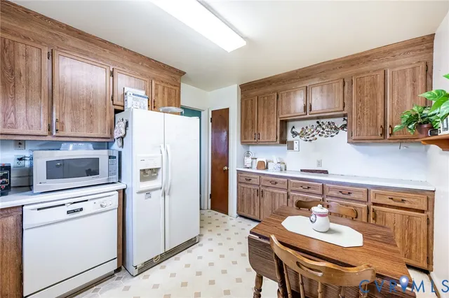 a kitchen with stainless steel appliances granite countertop a refrigerator sink stove microwave and cabinets