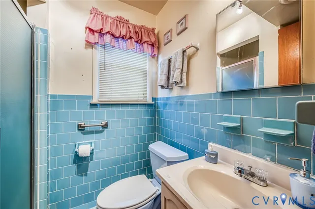 a bathroom with a sink mirror and toilet