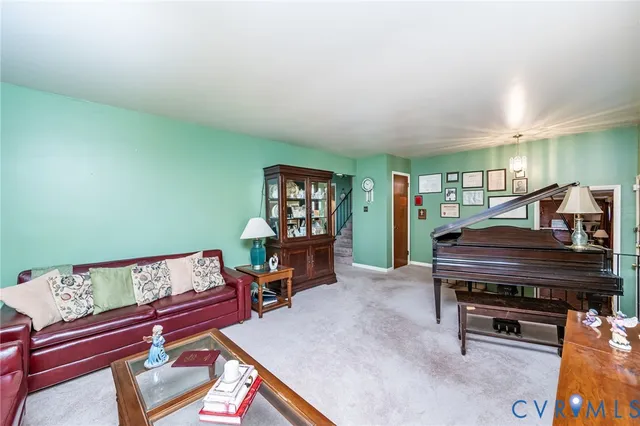 a living room with furniture and a piano