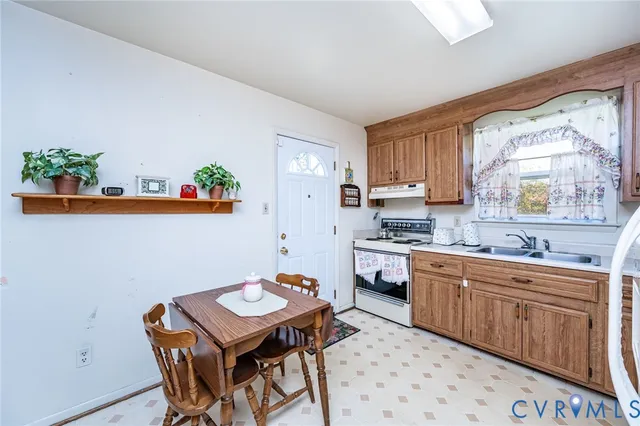 a kitchen with a dining table chairs and white appliances